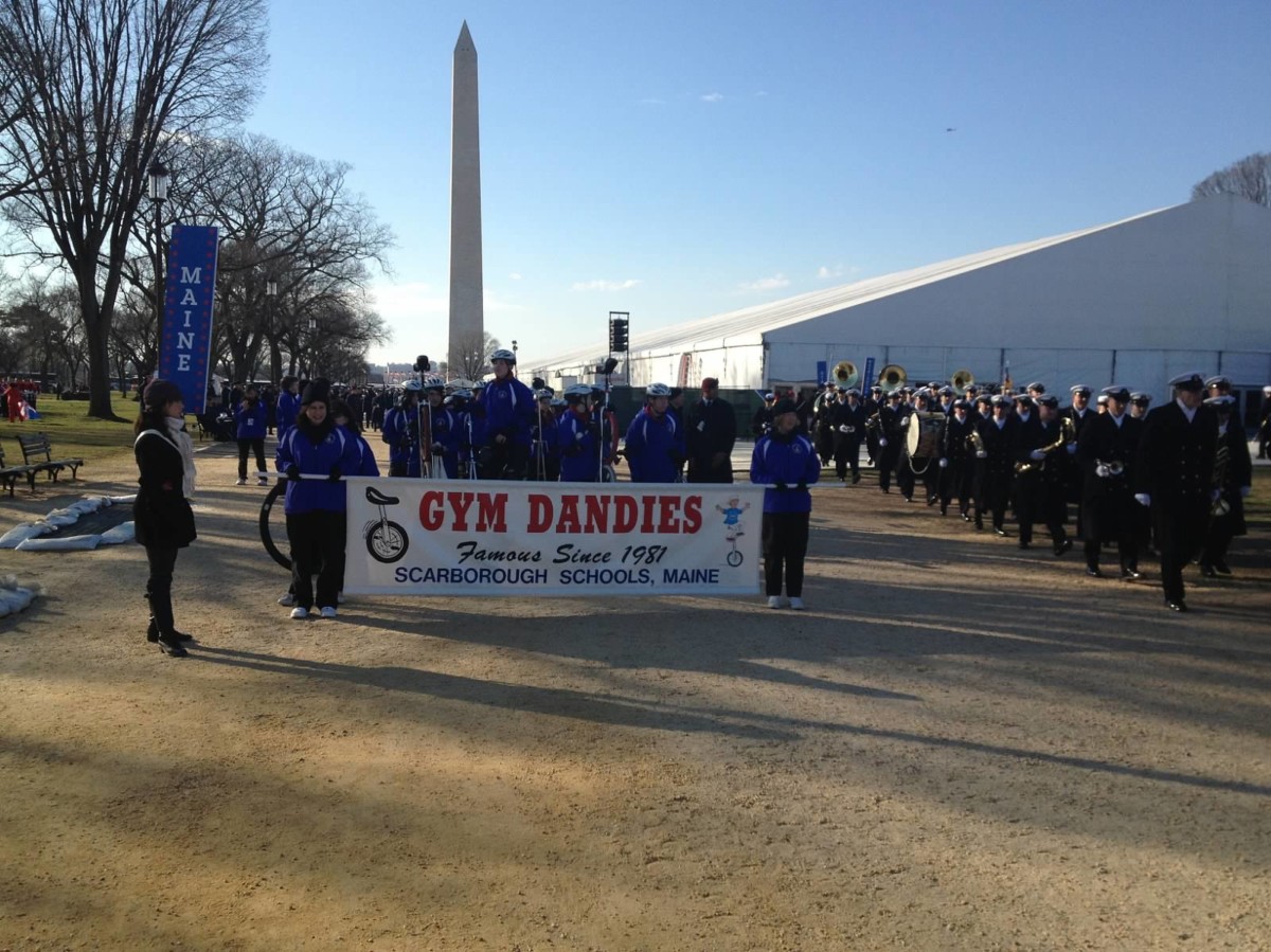 Gym Dandies Children's Circus lined up behind the parade banner