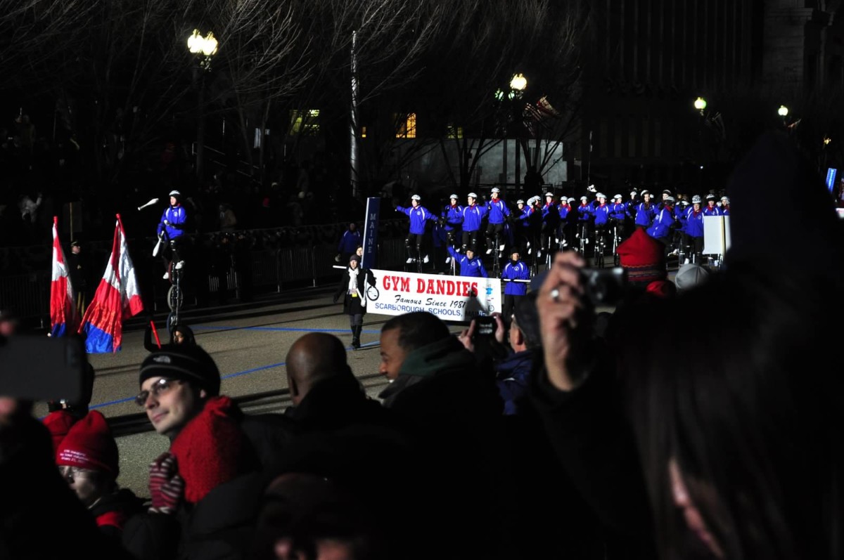 Gym Dandies riding into a bright spotlight at night
