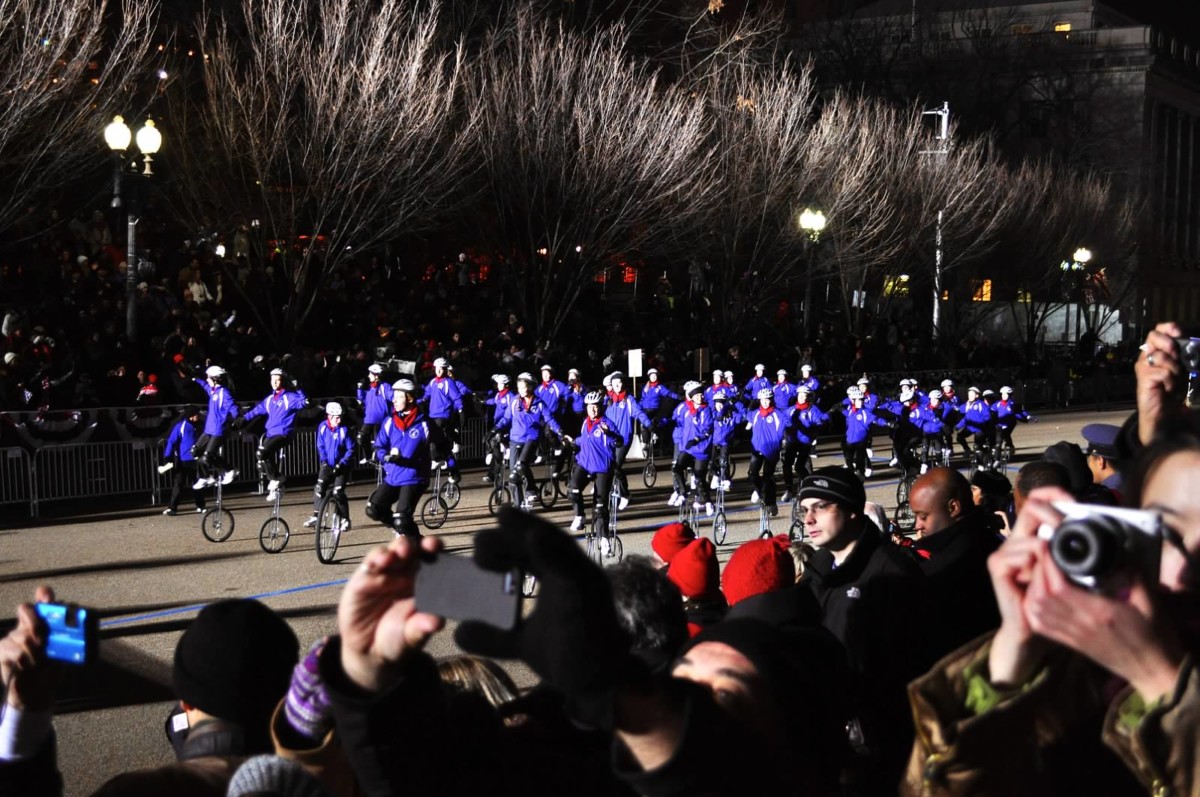 Gym Dandies riding into a bright spotlight at night