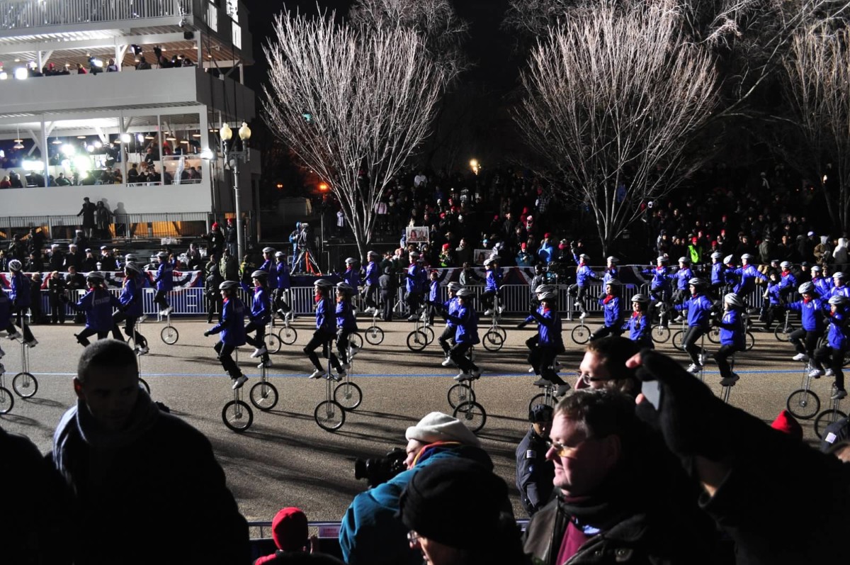 Gym Dandies riding into a bright spotlight at night